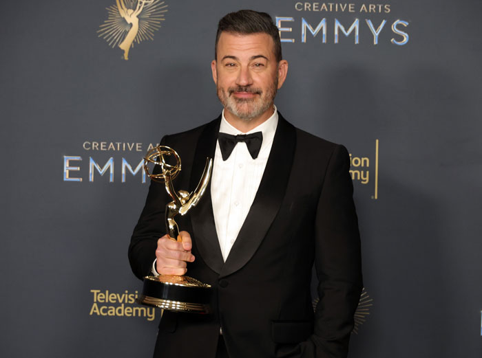 Jimmy Kimmel in a tuxedo holding an Emmy award amid announcements about his return after show suspension controversy. Jimmy Kimmel in a tuxedo holding an Emmy award amid announcements about his return after show suspension controversy.
