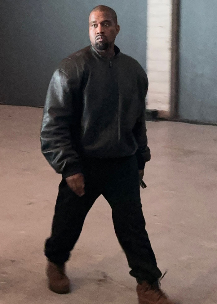 Kanye West walking in a dark jacket and pants, sparking controversy over public listing of daughter North in betrayal list. Kanye West walking in a dark jacket and pants, sparking controversy over public listing of daughter North in betrayal list.