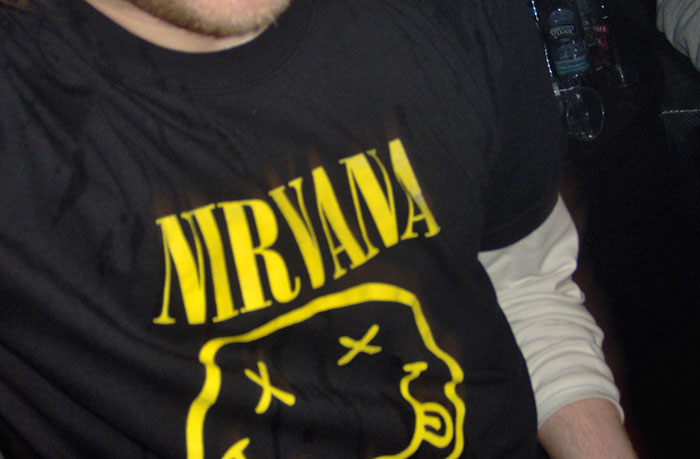 Person wearing a black Nirvana t-shirt showing the inclusion of AI into everything in modern trends concept.