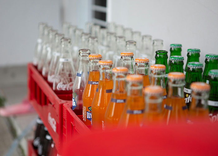 Crates filled with various common purchases like bottled sodas people have ditched due to ridiculous price tags.