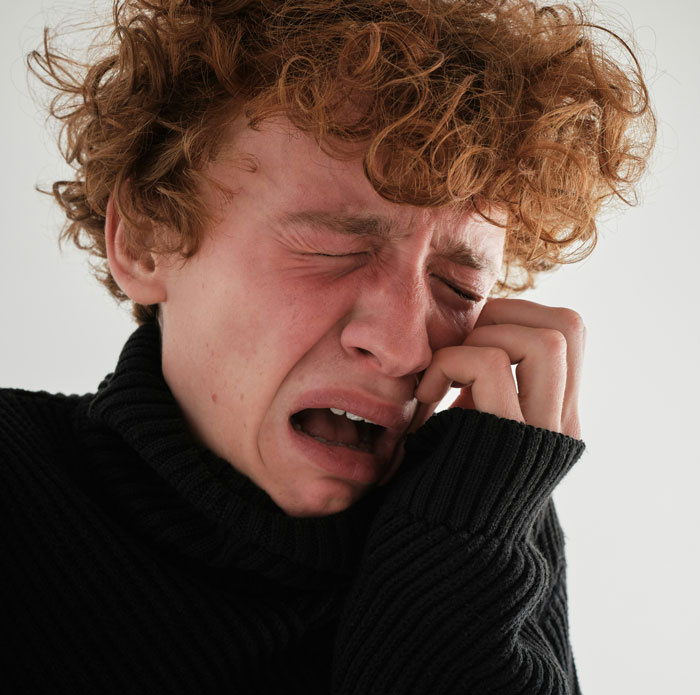 Young man crying and distressed after parents expect son to give up his life to care for autistic brother Young man crying and distressed after parents expect son to give up his life to care for autistic brother