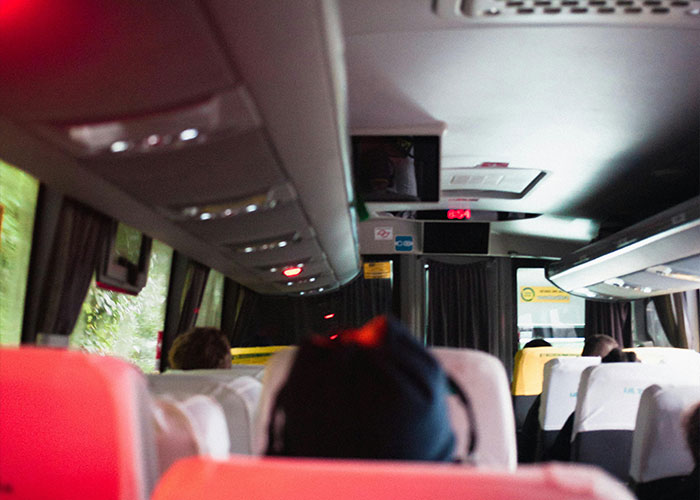 Interior of a dimly lit bus with passengers seated, evoking a sense of suspense for terrifying true stories.