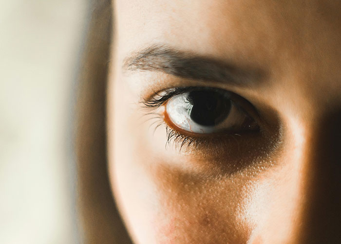 Close-up of a man’s eye showing discomfort, illustrating the creepy things women do that cross the line according to men.