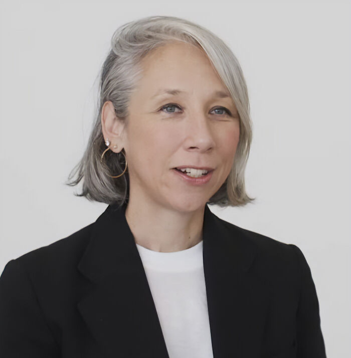 Woman with short gray hair wearing a black blazer and white shirt speaking about Keanu Reeves' girlfriend marriage rumors. Woman with short gray hair wearing a black blazer and white shirt speaking about Keanu Reeves' girlfriend marriage rumors.
