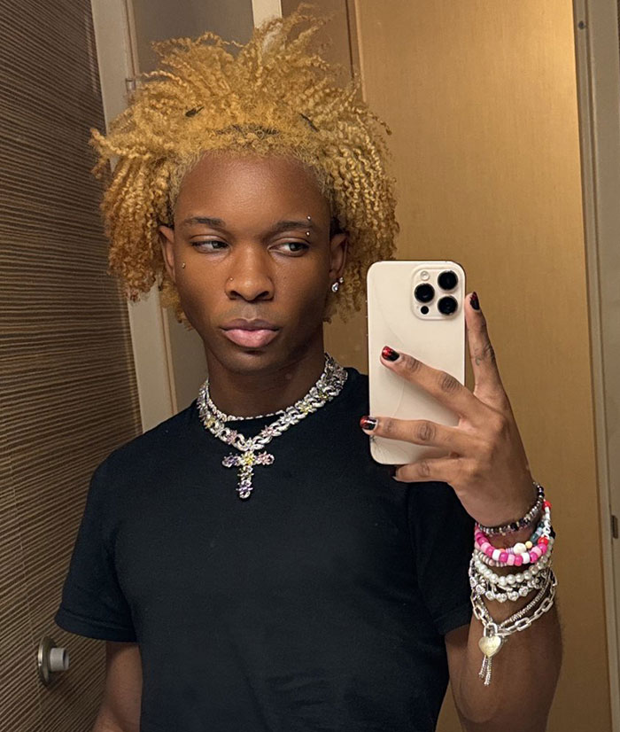 Singer takes selfie in mirror wearing black shirt and layered jewelry after decomposing body was found in abandoned Tesla case Singer takes selfie in mirror wearing black shirt and layered jewelry after decomposing body was found in abandoned Tesla case