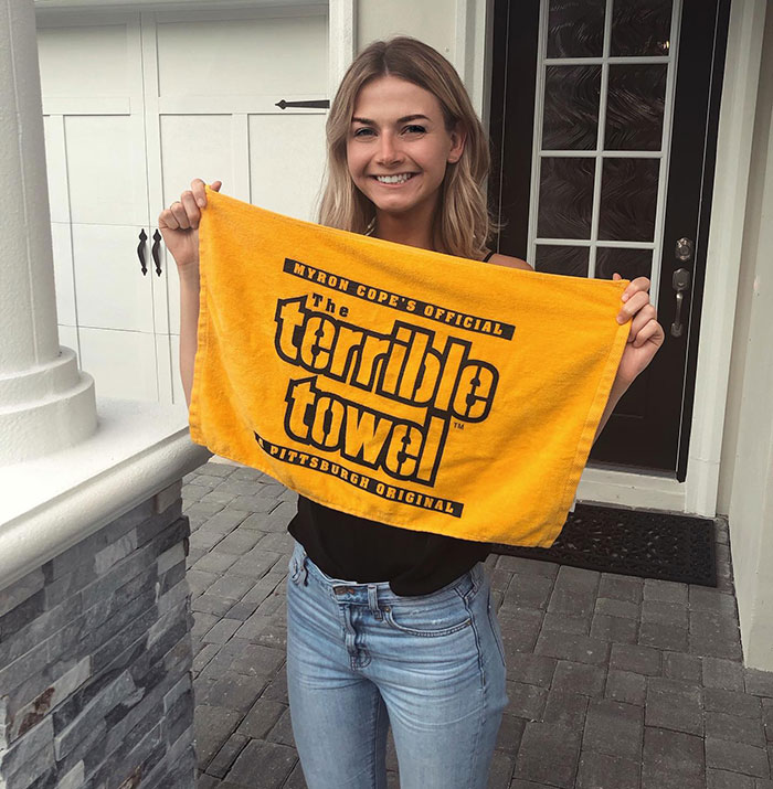 Young woman holding a yellow towel, with Brooklyn midwife’s dice game club safety concerns for non-white women topic.