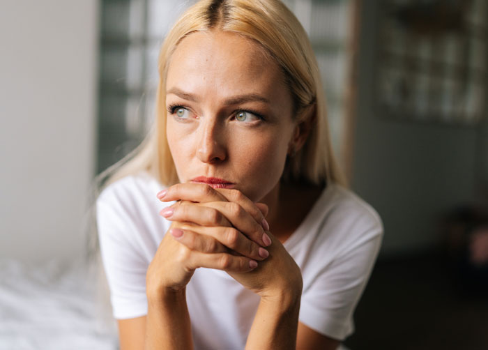 Thoughtful woman sitting indoors, reflecting deeply after giving husband another chance, learning a hard relationship lesson. Thoughtful woman sitting indoors, reflecting deeply after giving husband another chance, learning a hard relationship lesson.