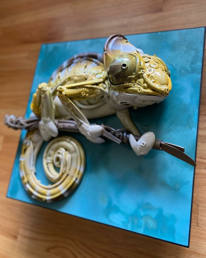 Chameleon sculpture made from recycled trash and found objects, showcasing stunning animal art and creative reuse.