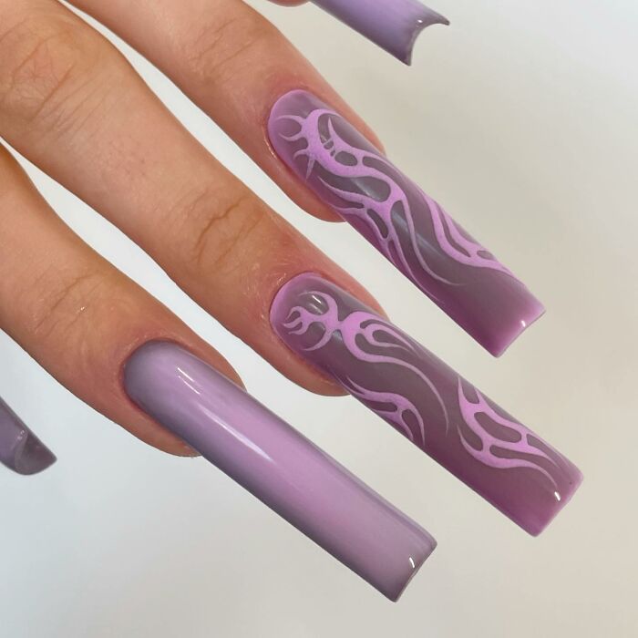 Long purple nails with flame-inspired nail designs in light and dark shades, showcasing unique nail designs.