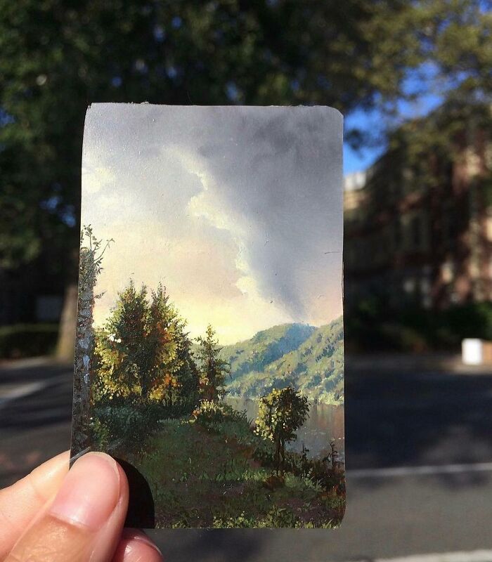 Small detailed painting by Dina Brodsky showing a natural landscape with trees, hills, and a cloudy sky.