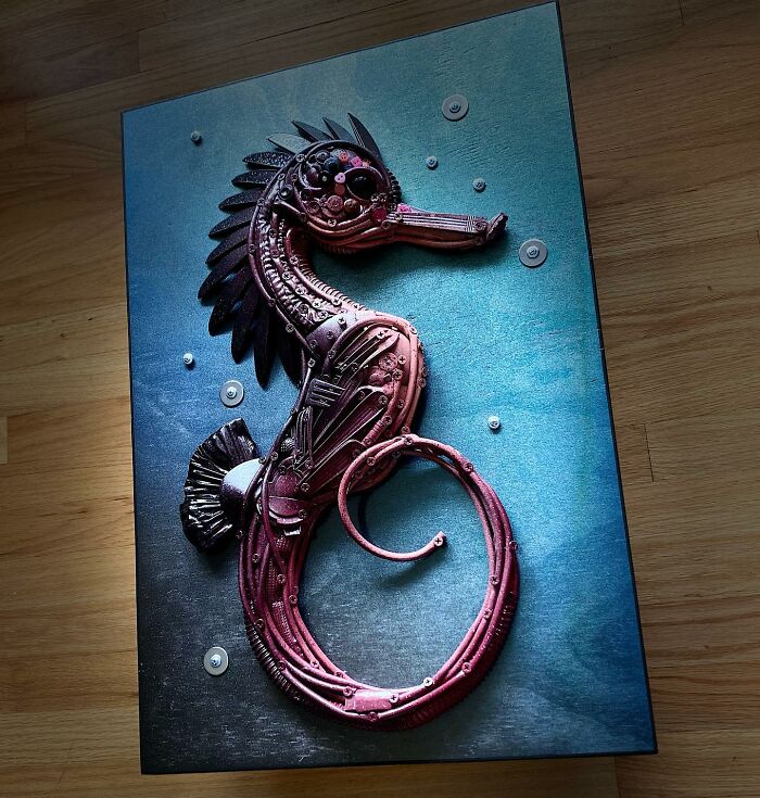 Seahorse sculpture made from recycled metal parts, showcasing stunning animal sculptures created from trash by this artist.