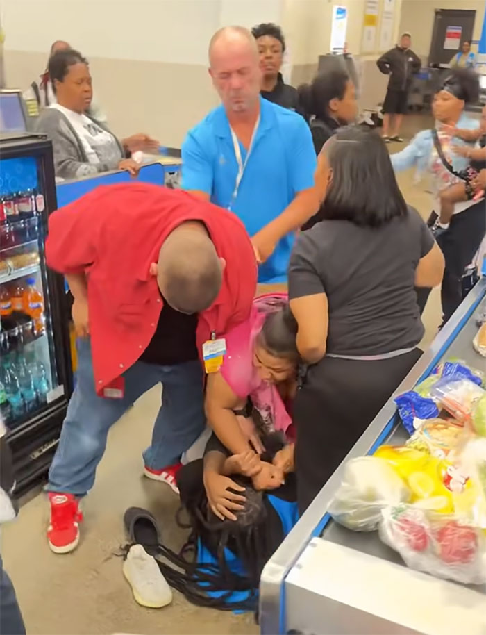 Walmart employee attacked by angry mob inside store with onlookers and chaotic scene near cashier area. Walmart employee attacked by angry mob inside store with onlookers and chaotic scene near cashier area.