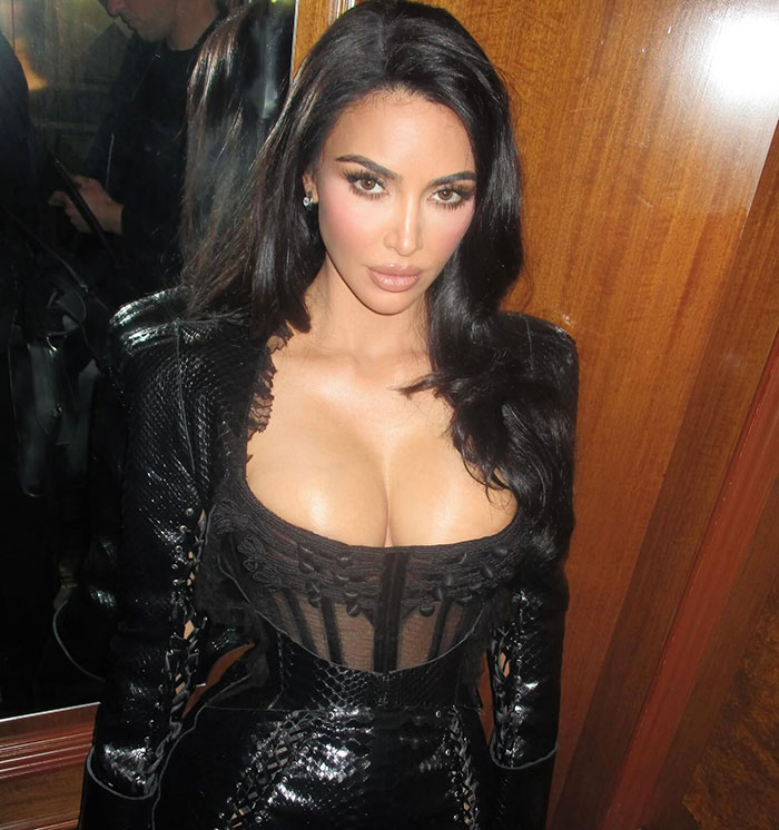 Kim Kardashian posing in a black outfit amid controversy over North West’s middle finger dermal piercing at age 12. Kim Kardashian posing in a black outfit amid controversy over North West’s middle finger dermal piercing at age 12.