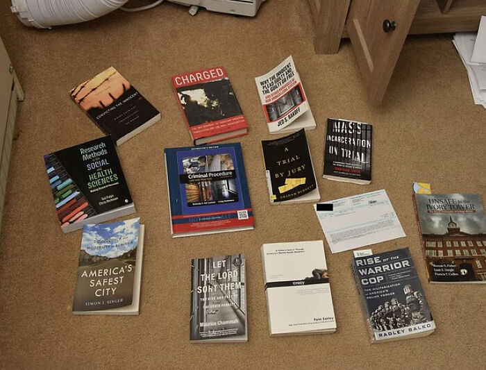 Books about criminal procedure and Idaho crimes laid out on carpet in relation to Bryan Kohberger's mom discussing Idaho crimes before arrest. Books about criminal procedure and Idaho crimes laid out on carpet in relation to Bryan Kohberger's mom discussing Idaho crimes before arrest.
