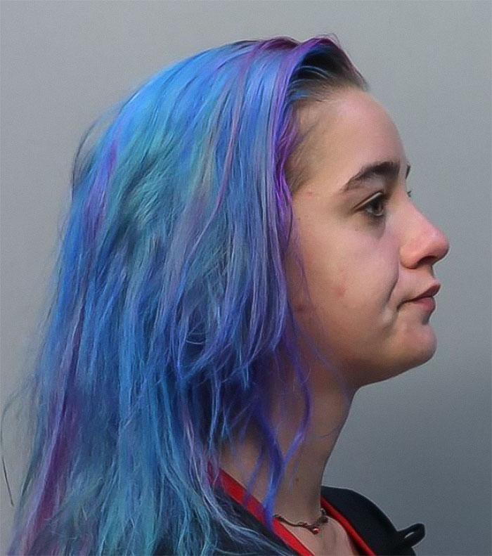Profile view of a young woman with blue and purple hair, related to a couple arrested for hotboxing in a car. Profile view of a young woman with blue and purple hair, related to a couple arrested for hotboxing in a car.