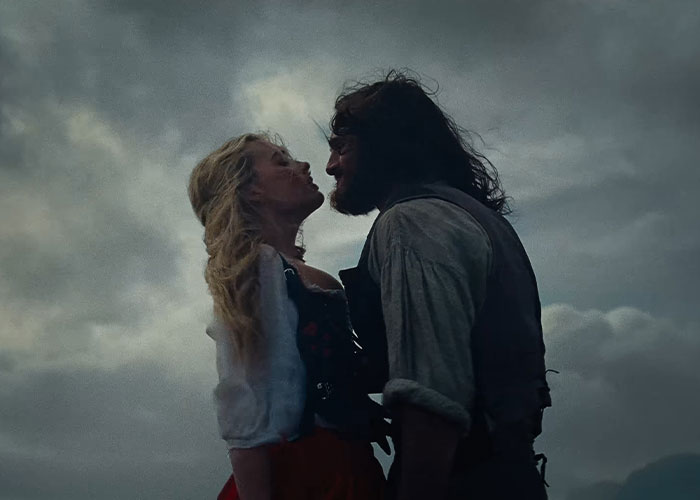Margot Robbie and Jacob Elordi in a dark moody scene from Wuthering Heights teaser set in the 1800s. Margot Robbie and Jacob Elordi in a dark moody scene from Wuthering Heights teaser set in the 1800s.