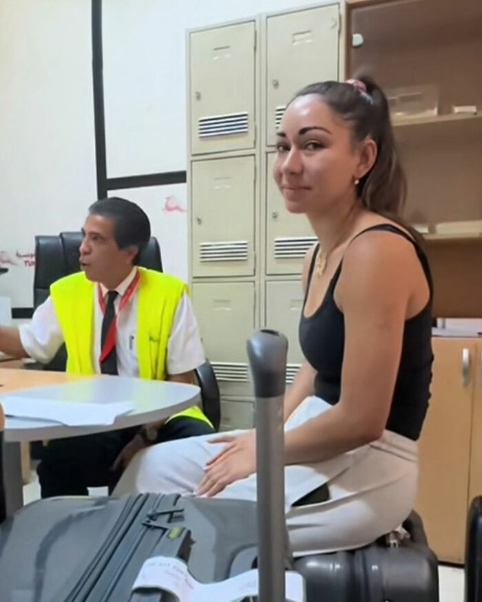 Young confused tourists sitting with luggage at airport, speaking with staff after mistakenly boarding flight to Africa. Young confused tourists sitting with luggage at airport, speaking with staff after mistakenly boarding flight to Africa.