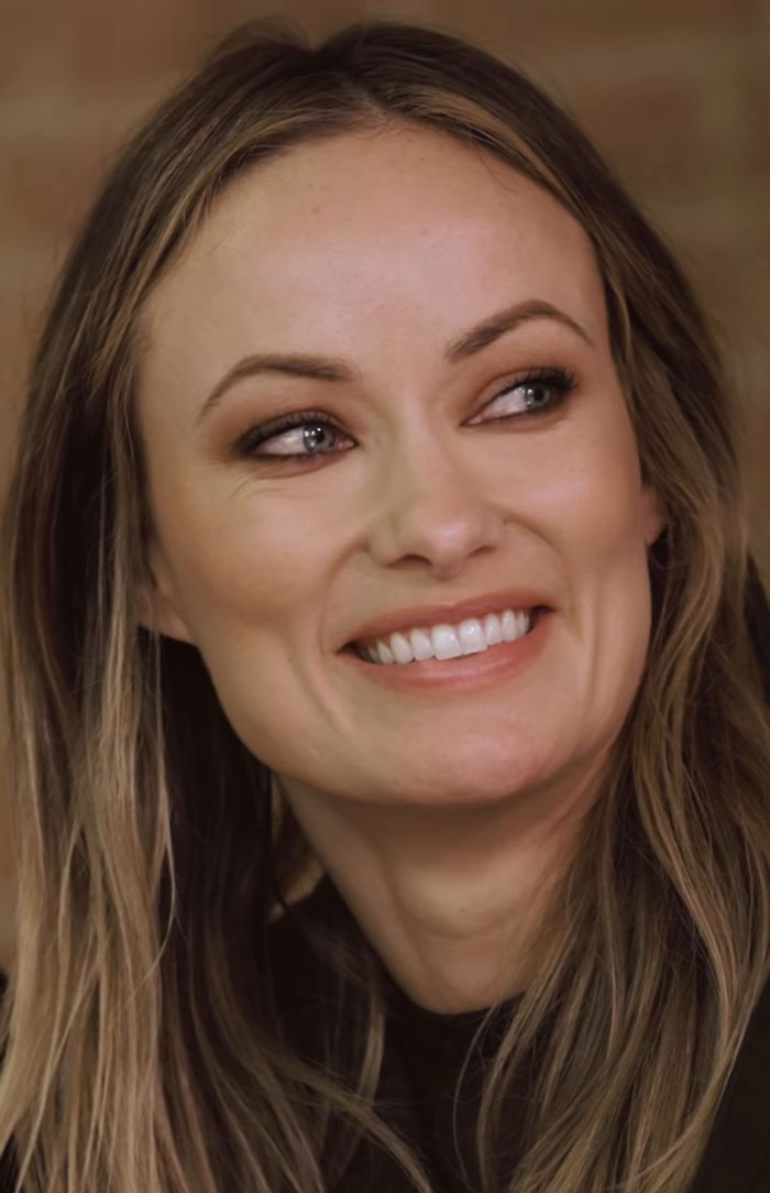 Olivia Wilde smiling with natural makeup and loose hair, highlighting her toned abs and sheer outfit at New York Fashion Week Olivia Wilde smiling with natural makeup and loose hair, highlighting her toned abs and sheer outfit at New York Fashion Week