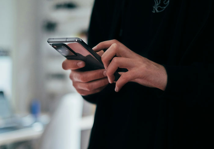Person holding and looking at a smartphone, illustrating the moment a glance at a phone changed everything.