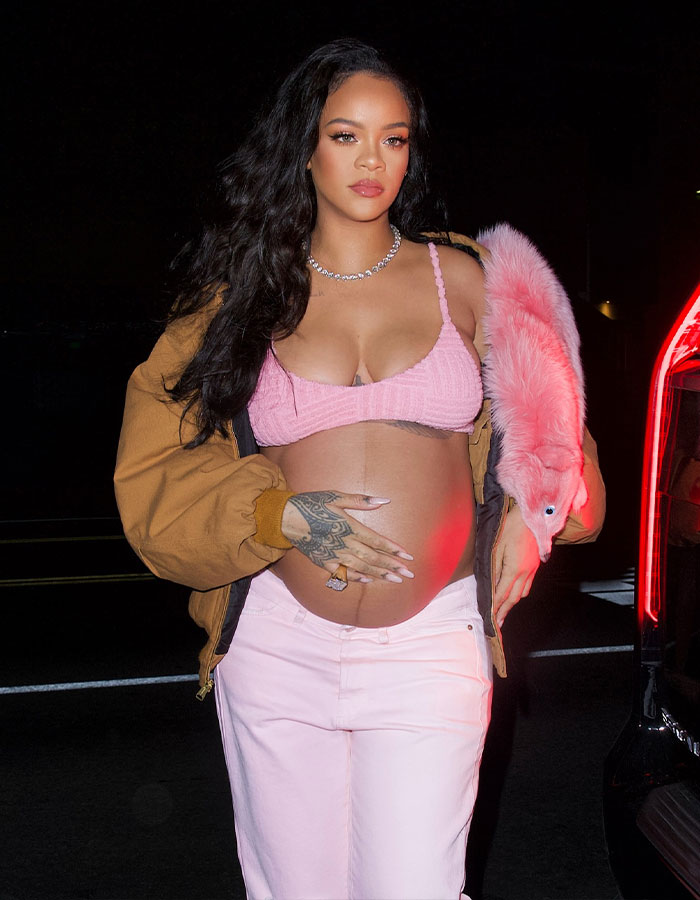 Pregnant Rihanna in a pink top and jacket, as fans urge her to change the cruel name given to her newborn daughter. Pregnant Rihanna in a pink top and jacket, as fans urge her to change the cruel name given to her newborn daughter.