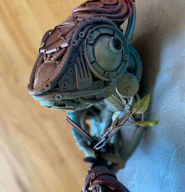 Intricate animal sculpture made from trash materials, showcasing vibrant colors and detailed recycled art craftsmanship.