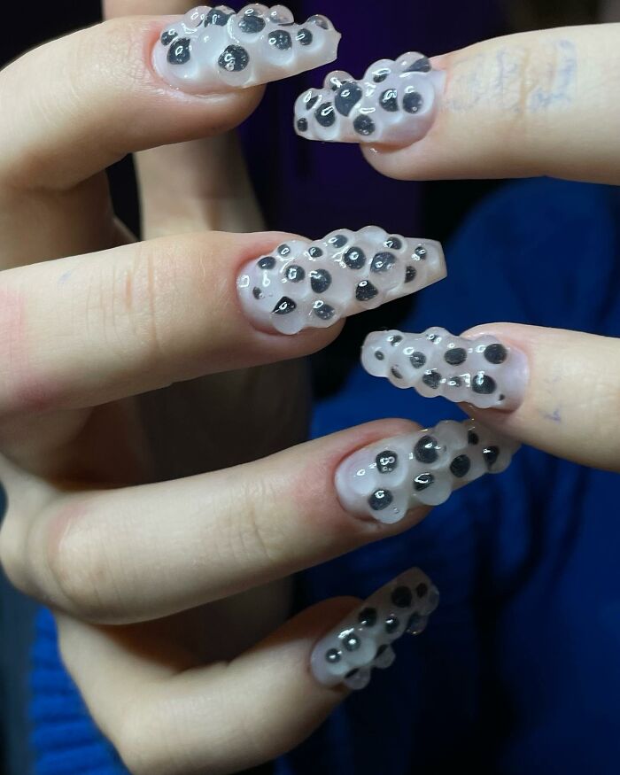 Unique 3D textured nail designs with black spots on translucent nails, showcasing bold and creative nail designs.