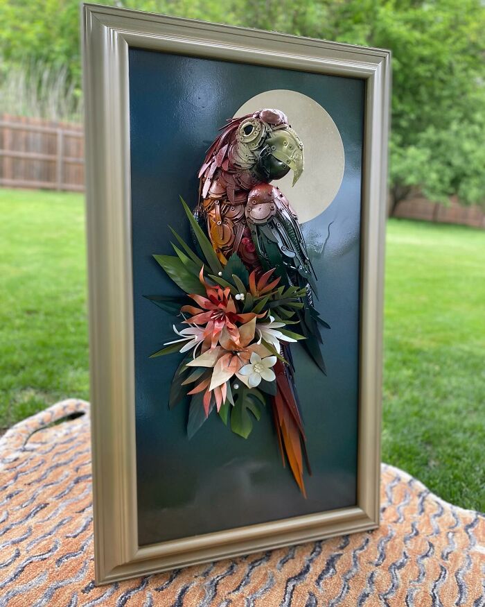 Parrot sculpture made from recycled metal trash, showcasing stunning animal sculpture art with detailed colorful parts.