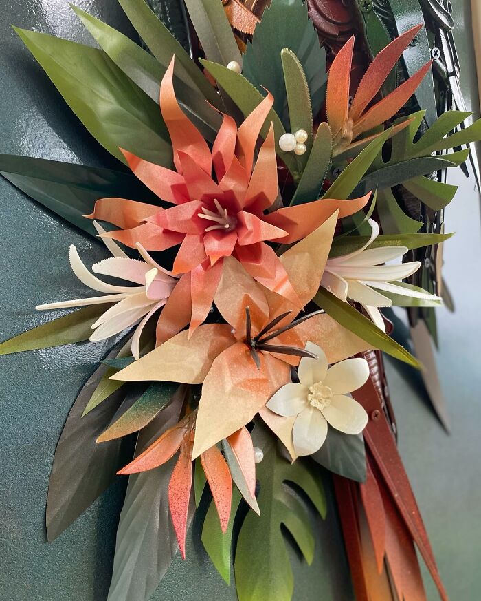 Parrot sculpture made from recycled metal trash, showcasing stunning animal sculpture art with detailed colorful parts.