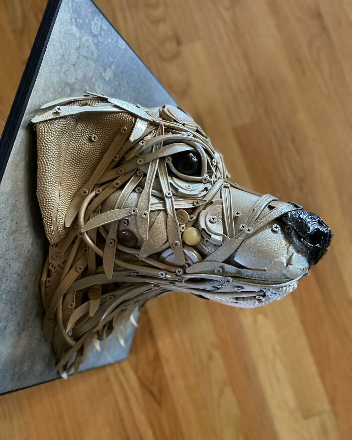 Dog sculpture made from trash materials, showcasing stunning animal sculptures created by a talented artist.