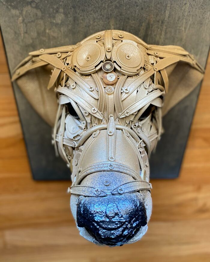 Dog sculpture made from trash materials, showcasing stunning animal sculptures created by a talented artist.