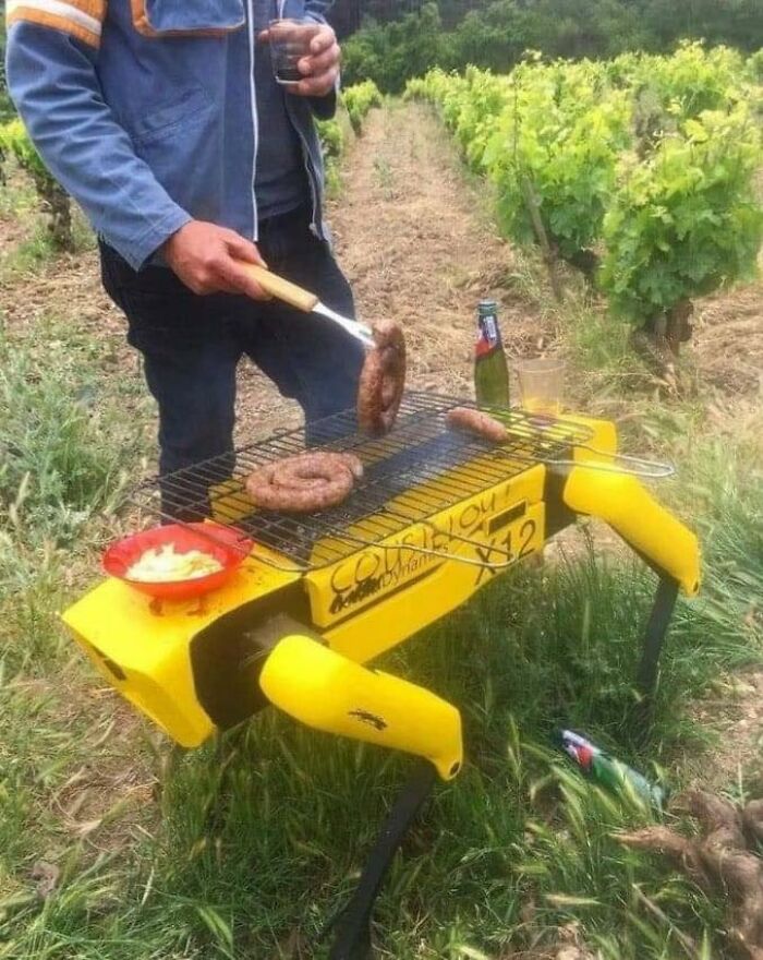 Man grilling sausages on a creative DIY barbecue in a vineyard, showcasing unique Eastern Europe humor and culture.