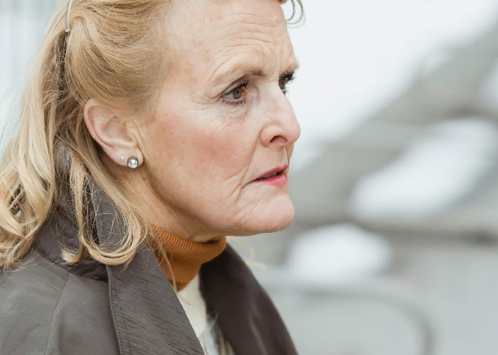 Elderly woman with a concerned expression outdoors, illustrating emotions related to mother poisoned me situation. Elderly woman with a concerned expression outdoors, illustrating emotions related to mother poisoned me situation.