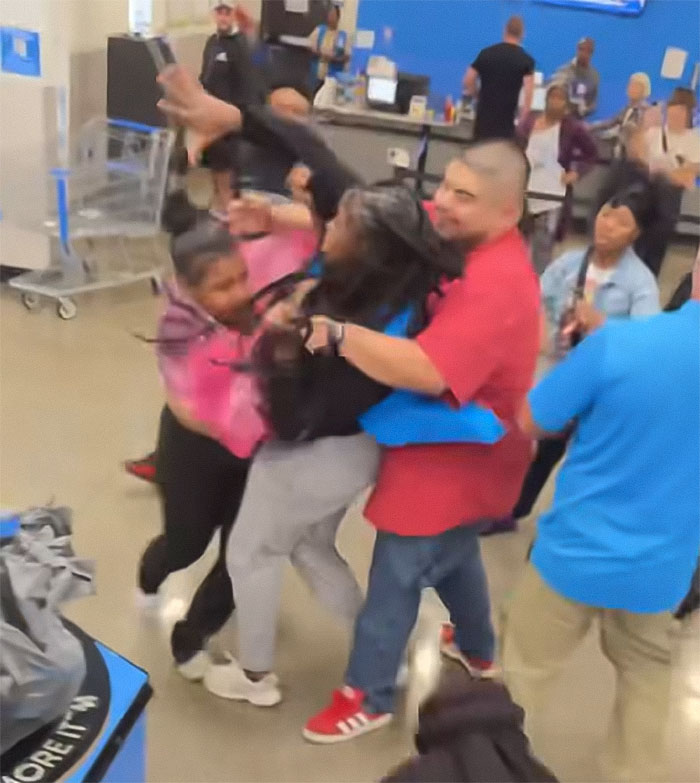 Crowd physically confronting Walmart employee during chaotic altercation inside the store with an angry mob ambush. Crowd physically confronting Walmart employee during chaotic altercation inside the store with an angry mob ambush.