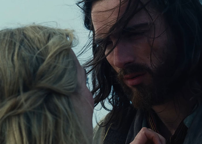 Close-up of Margot Robbie and Jacob Elordi in a moody scene from Wuthering Heights teaser evoking 1800s period drama. Close-up of Margot Robbie and Jacob Elordi in a moody scene from Wuthering Heights teaser evoking 1800s period drama.