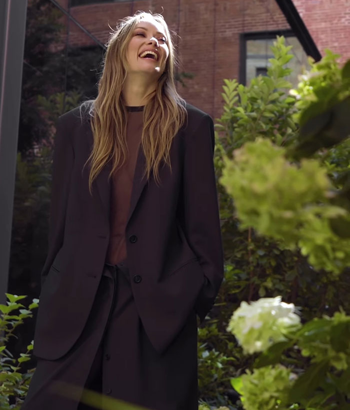 Olivia Wilde wearing a sheer outfit and flashing her toned abs, posing outdoors amidst greenery at New York Fashion Week. Olivia Wilde wearing a sheer outfit and flashing her toned abs, posing outdoors amidst greenery at New York Fashion Week.