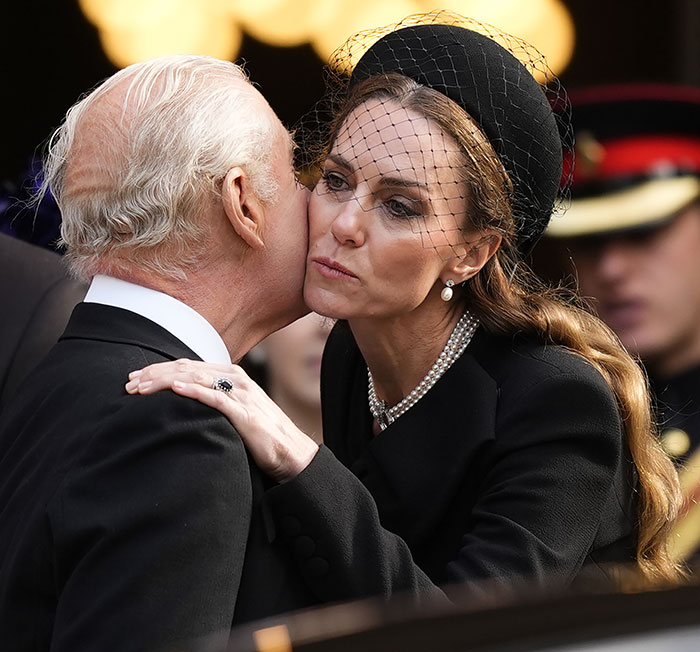 Kate Middleton kindly says goodbye to King Charles with a kiss on the cheek after royal funeral, both in mourning attire. Kate Middleton kindly says goodbye to King Charles with a kiss on the cheek after royal funeral, both in mourning attire.
