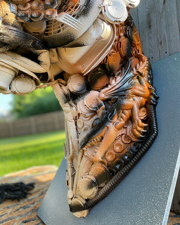 Animal sculpture made from recycled trash materials, showcasing intricate details and creative reuse in art.