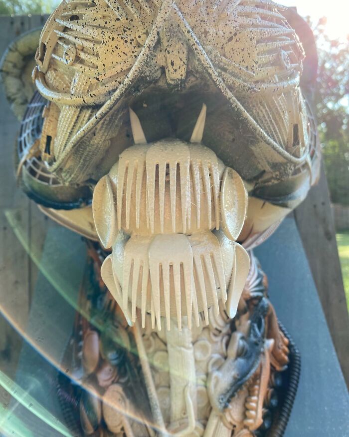 Animal sculpture made from recycled trash materials, showcasing intricate details and creative reuse in art.