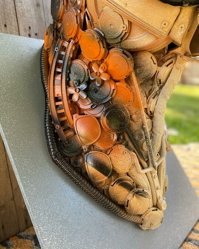 Animal sculpture made from recycled trash materials, showcasing intricate details and creative reuse in art.