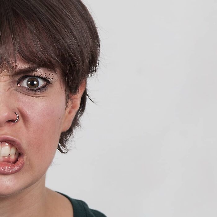 Woman showing two different facial expressions side-by-side, illustrating strong family DNA in a genetic portrait comparison.