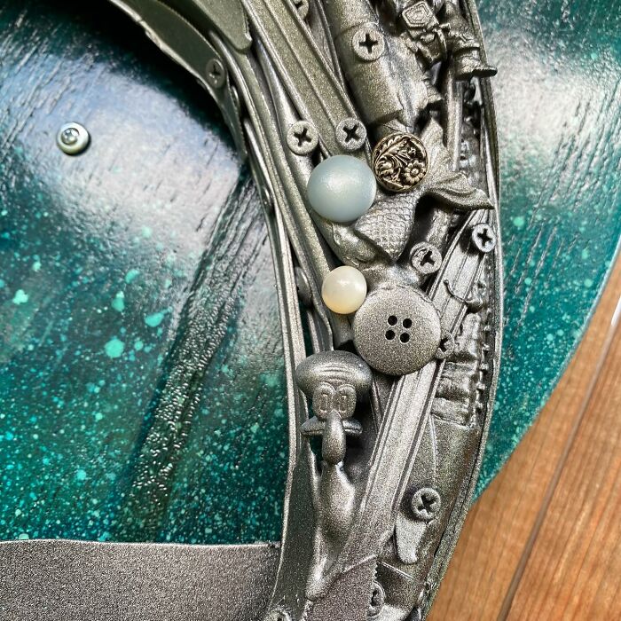 Metal dolphin sculpture made from trash and recycled items, showcasing stunning animal art with intricate details.