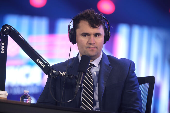 Conspiracy theorists discussing Michigan church tragedy and Charlie Kirk attack during a podcast recording session. Conspiracy theorists discussing Michigan church tragedy and Charlie Kirk attack during a podcast recording session.