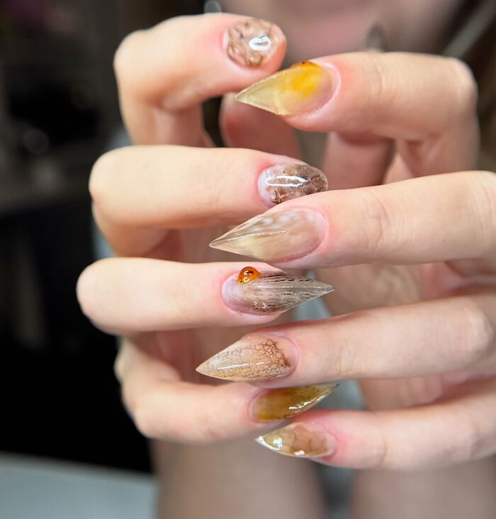 Unique nail designs featuring textured, translucent, and amber-inspired patterns in an edgy, rule-breaking style.