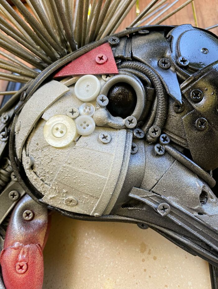 Intricate animal sculpture made from recycled trash and metal parts showcasing creative transformation and artistic craftsmanship.