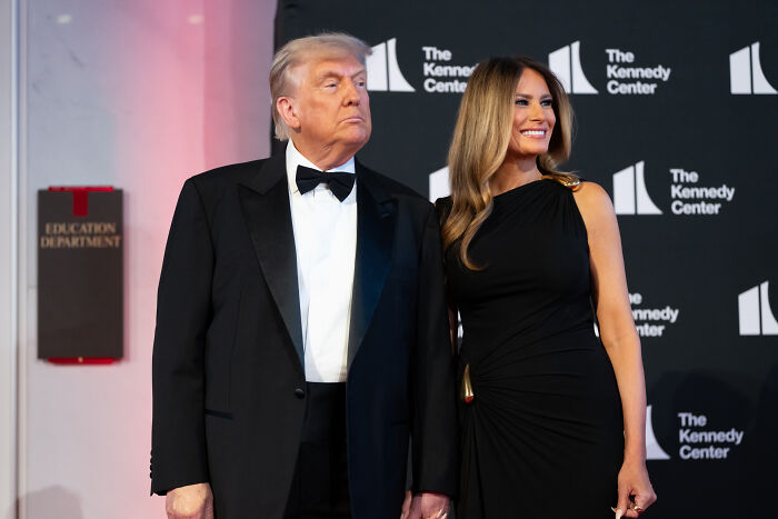 Donald Trump and Melania Trump at a formal event, body language experts analyzing finger-pointing and scolding interaction. Donald Trump and Melania Trump at a formal event, body language experts analyzing finger-pointing and scolding interaction.