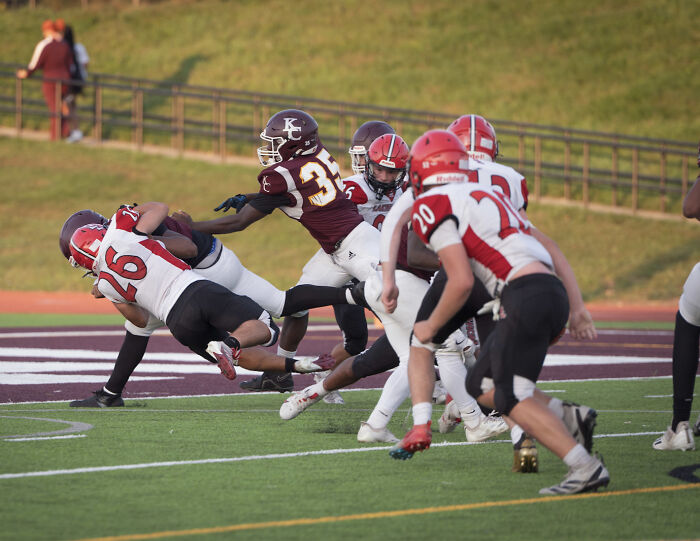 High school football players in action on field during a strong and decisive school response to injury incident. High school football players in action on field during a strong and decisive school response to injury incident.