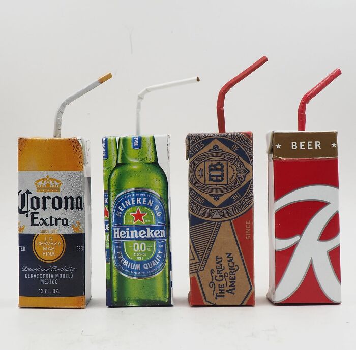 Four drink cartons made from recycled materials, showcasing witty commentary on modern life through artistic waste reuse.