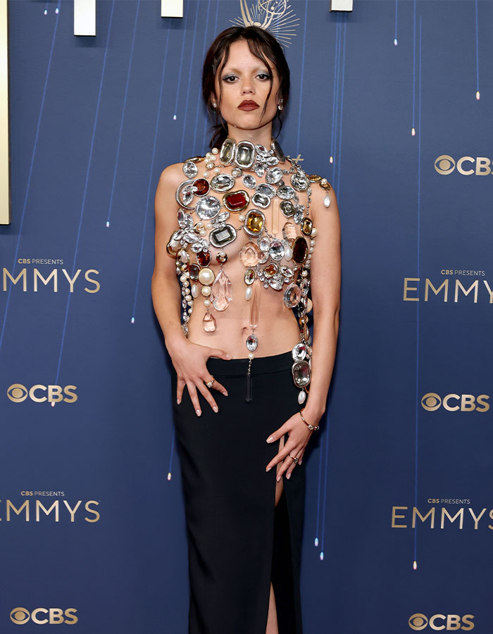 Jenna Ortega at the Emmys wearing a jeweled outfit, styled by her stylist after a viral painful wardrobe moment. Jenna Ortega at the Emmys wearing a jeweled outfit, styled by her stylist after a viral painful wardrobe moment.