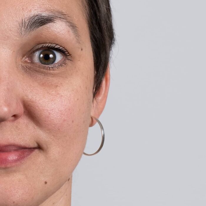 Woman with short dark hair and hoop earrings in a close-up portrait highlighting family DNA resemblance.