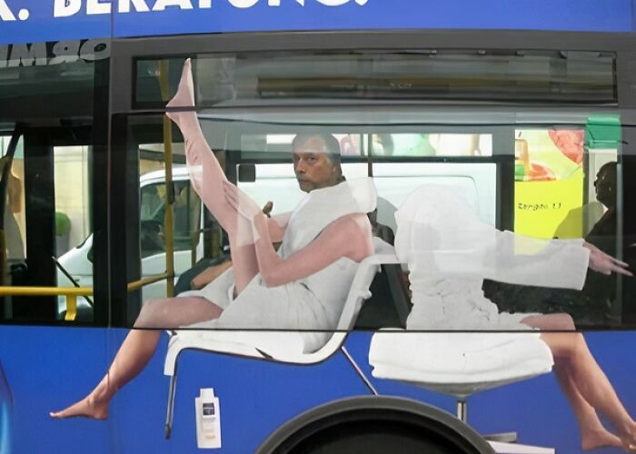 Bus ad with a person whose legs align humorously with the painted figure, an example of advertising placement fails.
